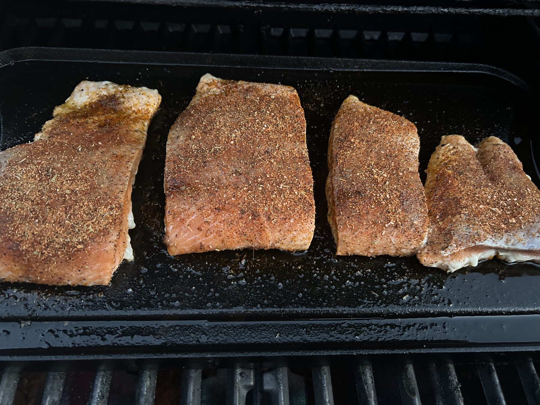 Salmon fillets coated in Creole Blackening Spice before cooking