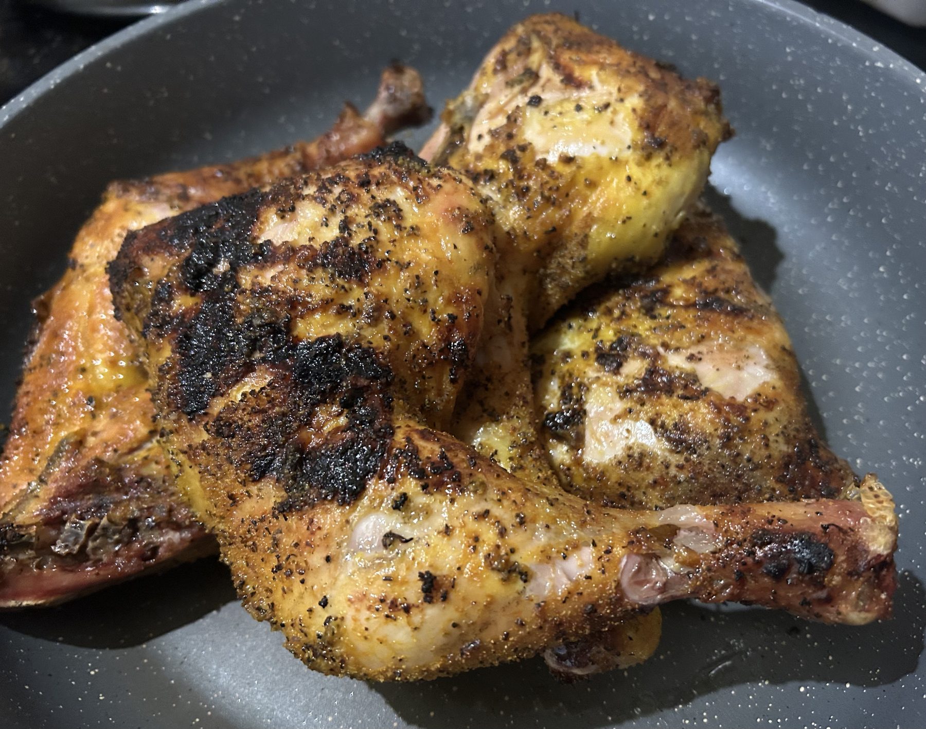Lemon Pepper BBQ chicken leg quarters with a dark grill crust