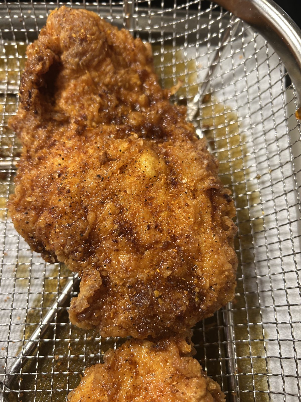 Crisp fried chicken cutlets resting on a wire rack