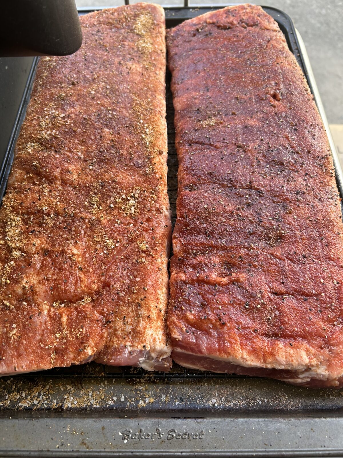 Two racks of St. Louis ribs with Perfect Rack Rib Rub applied, ready for the smoker