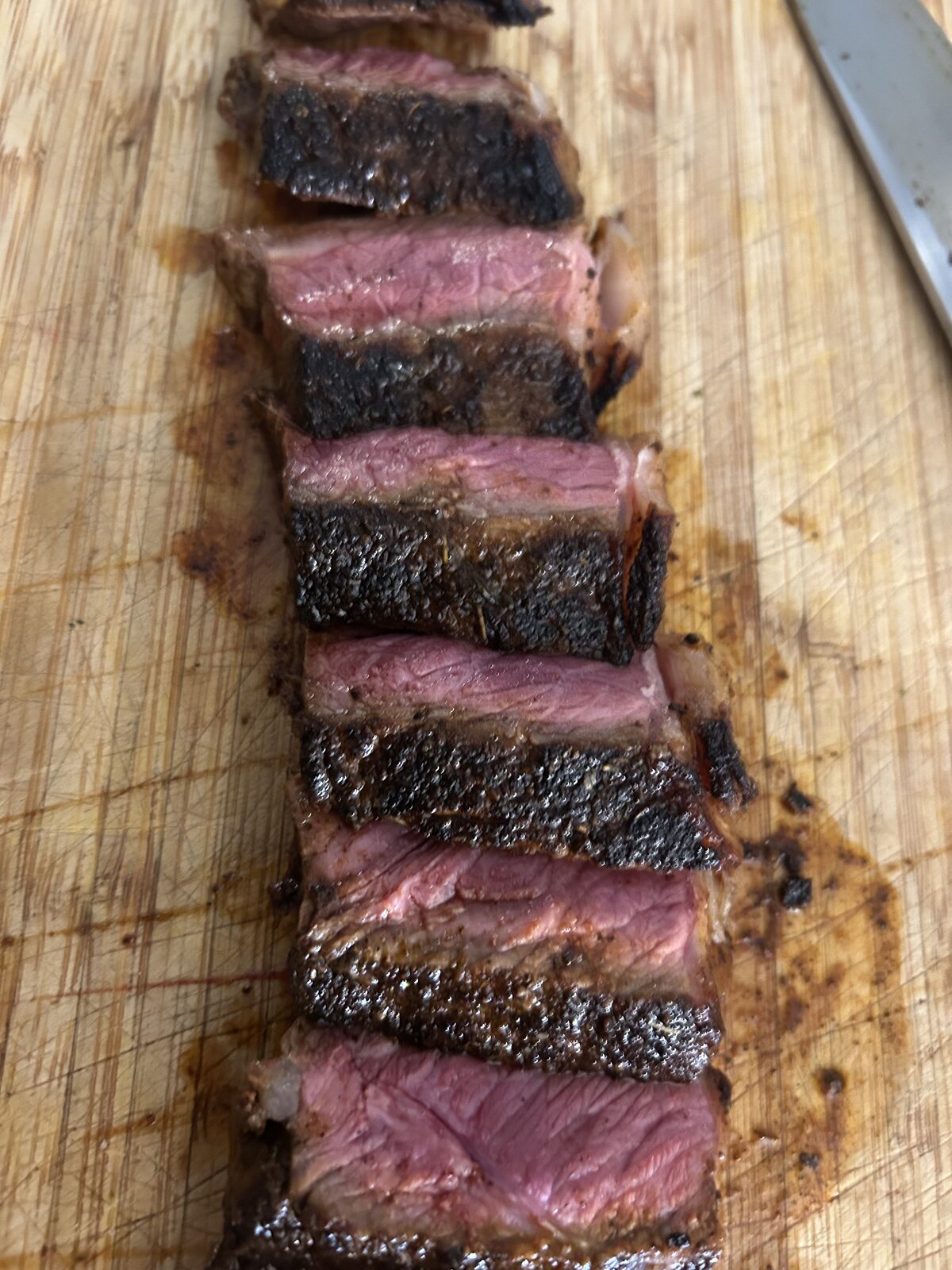 Sliced steak on a cutting board