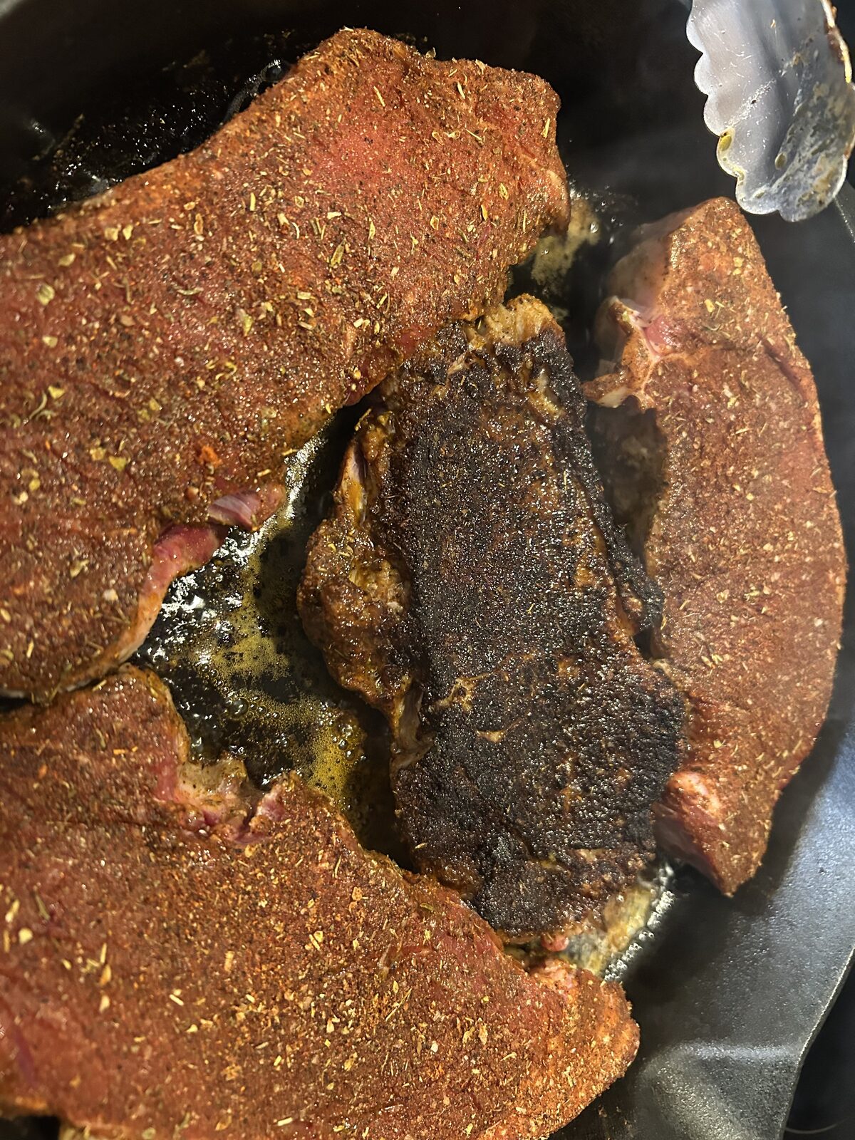 Steaks searing in cast iron